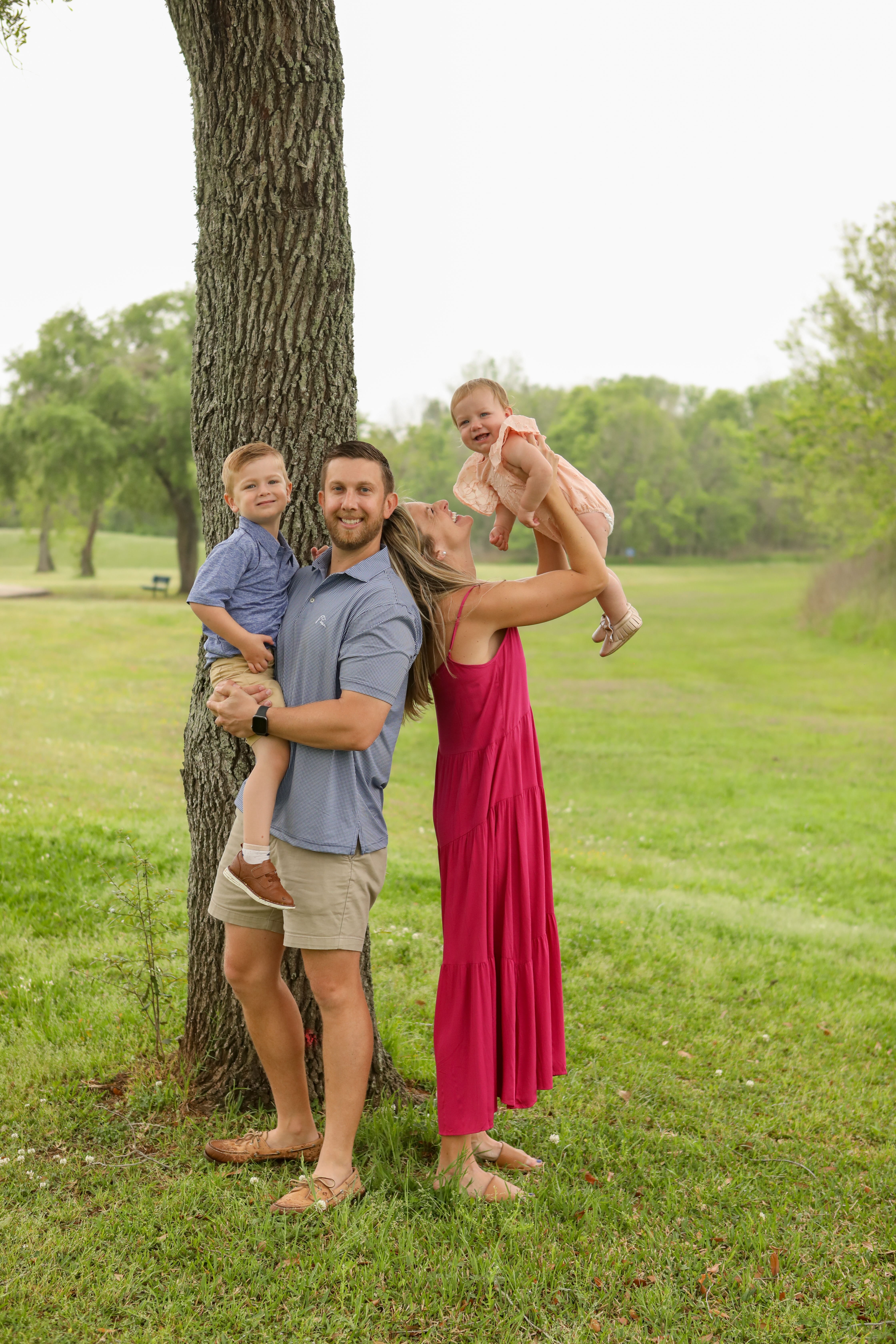 A family takes pictures in Kitty Hollow Park, Missouri City, Texas.
